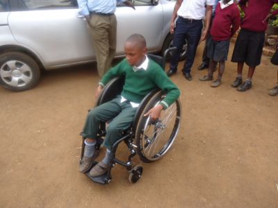 Patrick-Macharia-trying-out-his-new-Motivation-Wheelchair-he-has-just-received-from-KPO-in-school